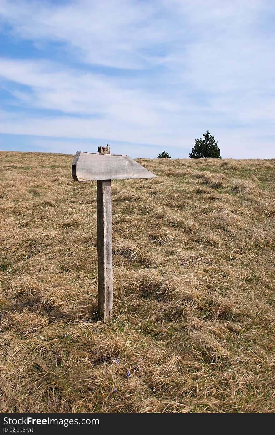 Direction sign for hikers on mountain path