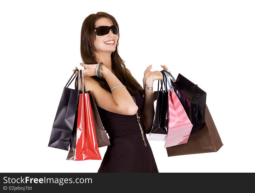 Brunette woman with sun glasses and lots of shopping bags. Brunette woman with sun glasses and lots of shopping bags