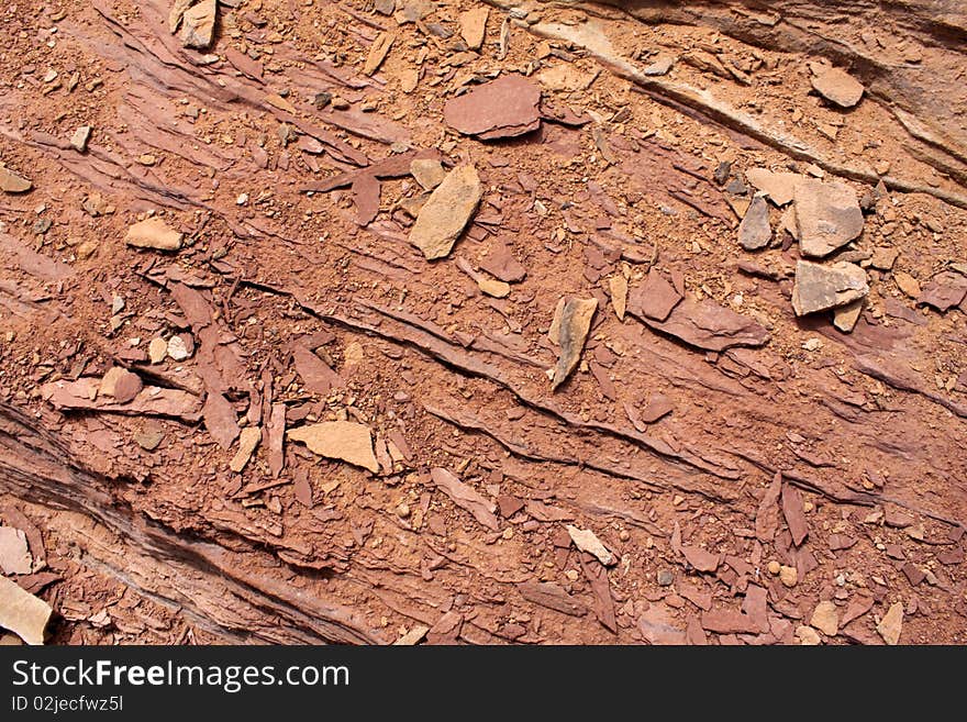 Close up of rocks on a red sandstone layer of rock. Close up of rocks on a red sandstone layer of rock.