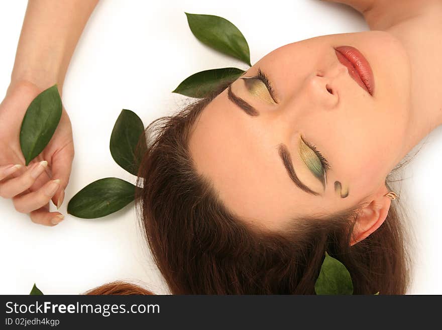 Beautiful young woman with green leaves. Beautiful young woman with green leaves