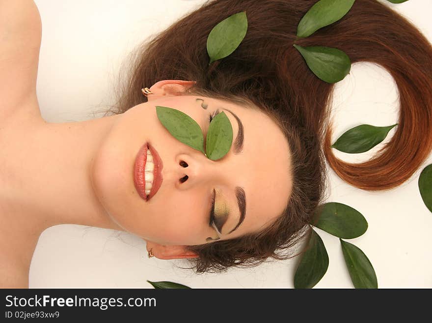 Beautiful young woman with green leaves. Beautiful young woman with green leaves