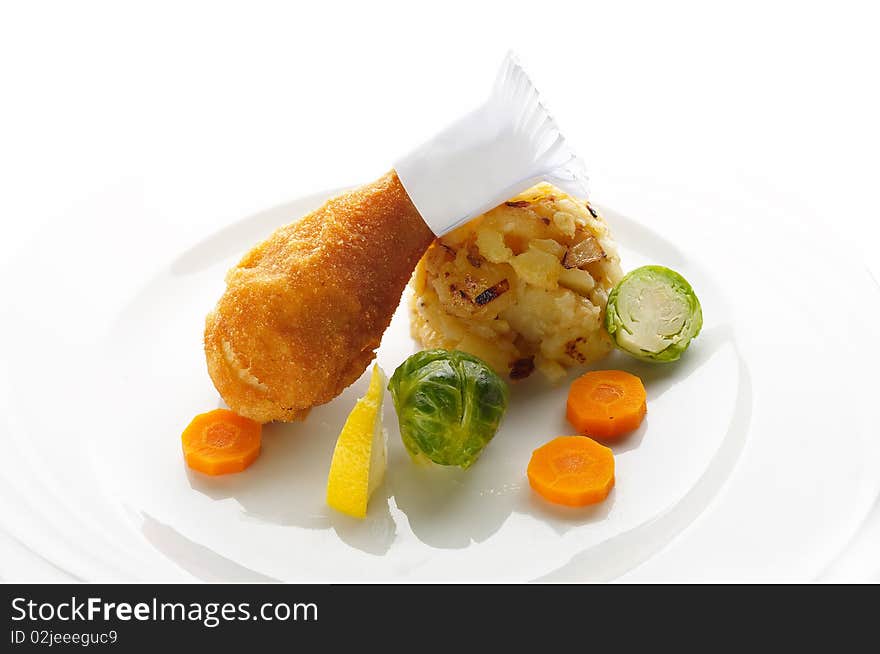 Fried chicken leg with mashed potato and vegetable