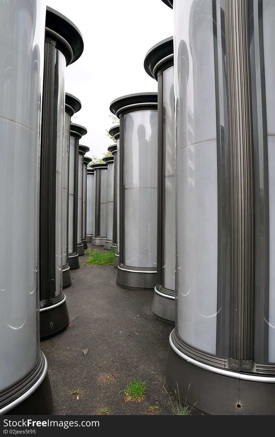 Rows of empty advertising columns stored in a backyard for later installation. Rows of empty advertising columns stored in a backyard for later installation