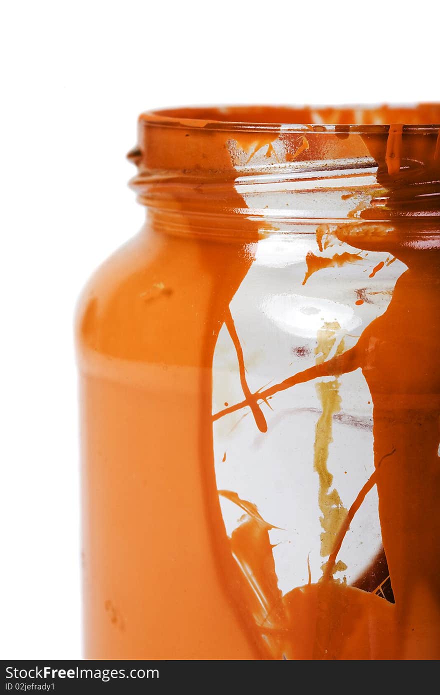 Empty glass jar with dried colored liquid close up