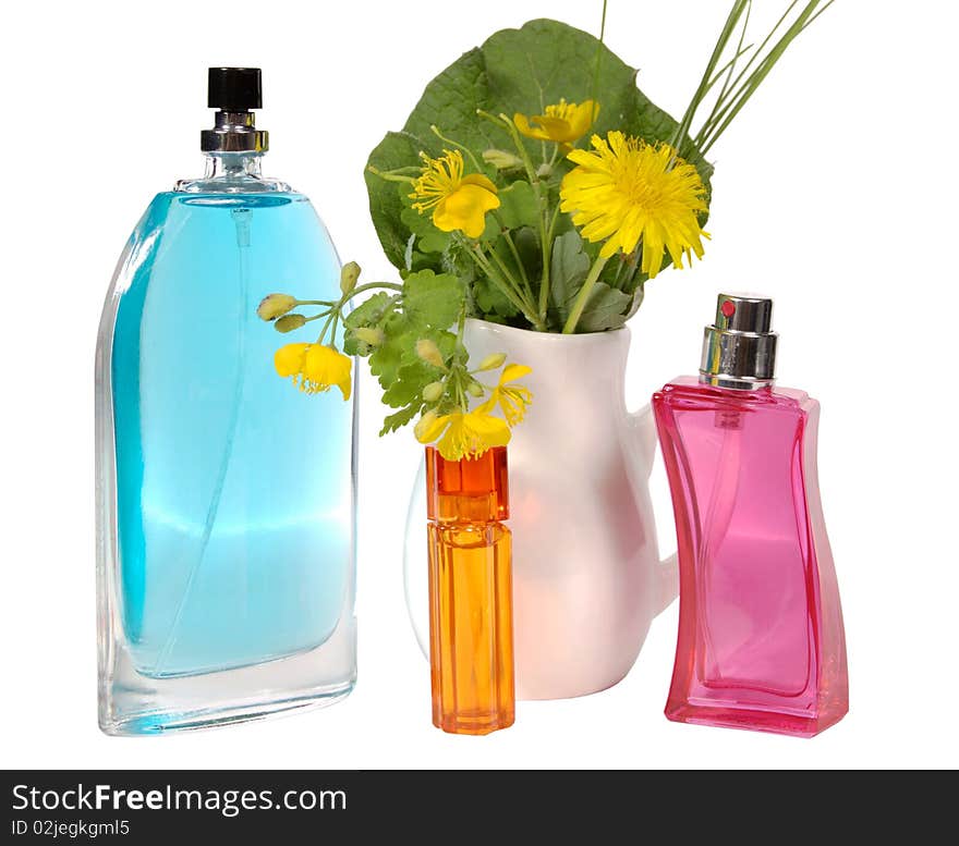 Bottles of female perfumery and bouquet dandelions