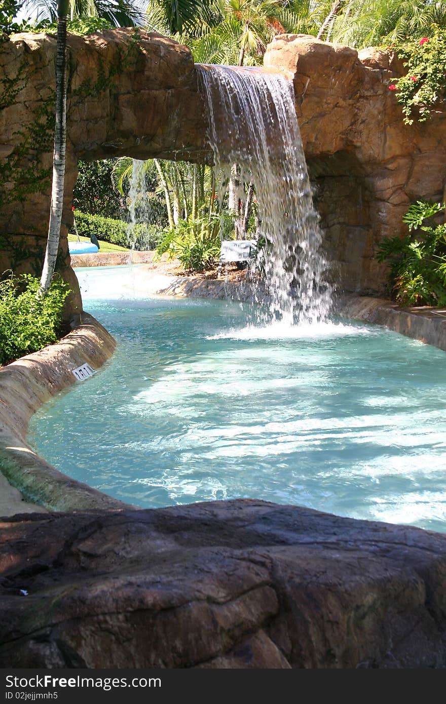 Waterfall throws it's water onto the circular tube ride. Waterfall throws it's water onto the circular tube ride