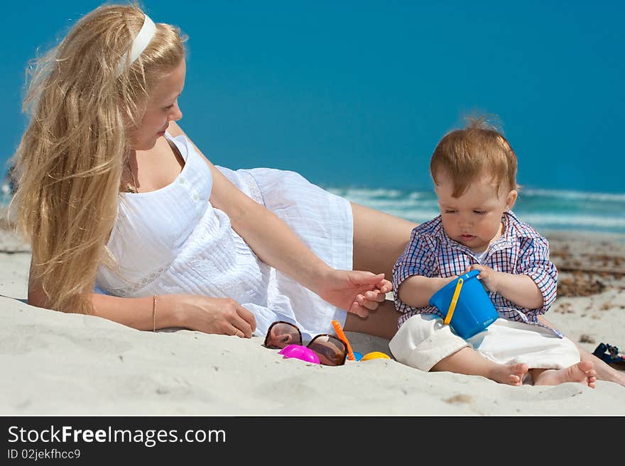 Child and mother on a beach. Child and mother on a beach