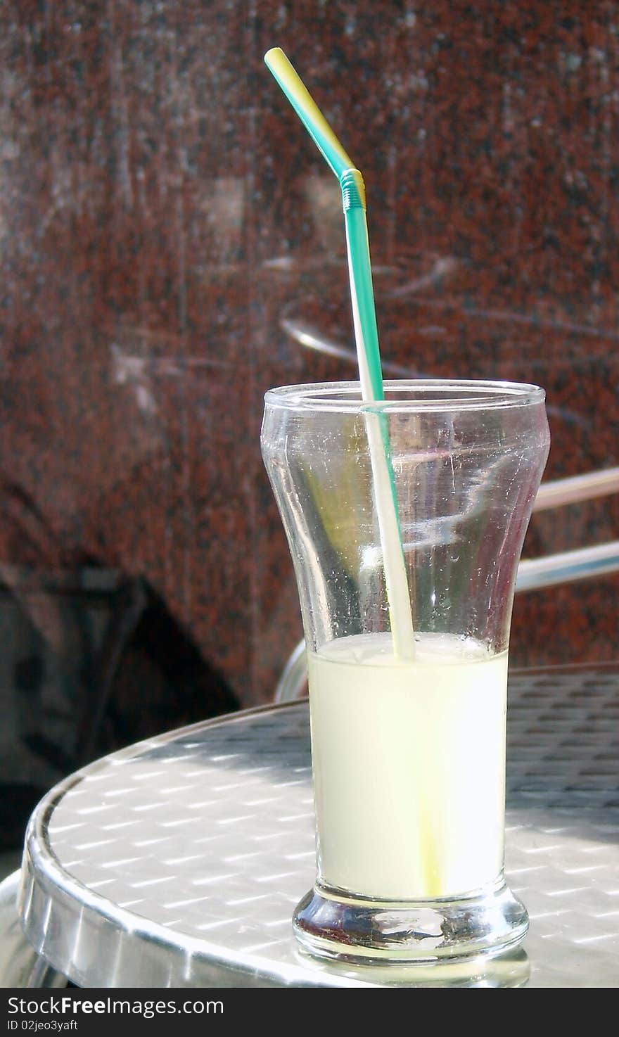 Close up view of a Lemonade glass in a terrace zinc table. Close up view of a Lemonade glass in a terrace zinc table