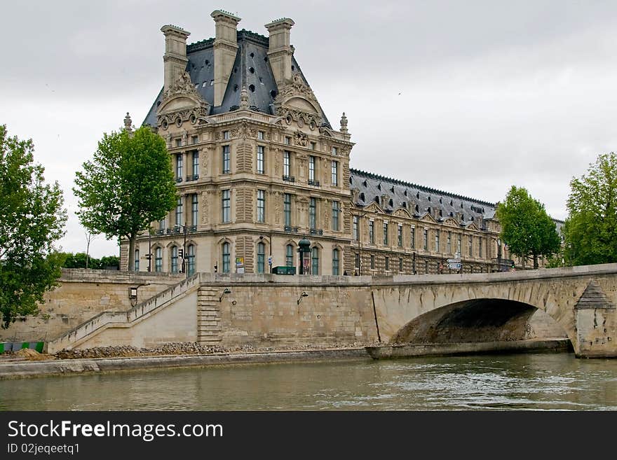 This shot of the Louvre Museum was taken from the Seine River on an overcast day. This shot of the Louvre Museum was taken from the Seine River on an overcast day.