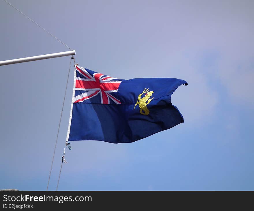 Blue ensign flag with motif flying in the wind