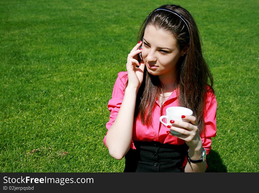 Young businesswoman drinking tea and talking