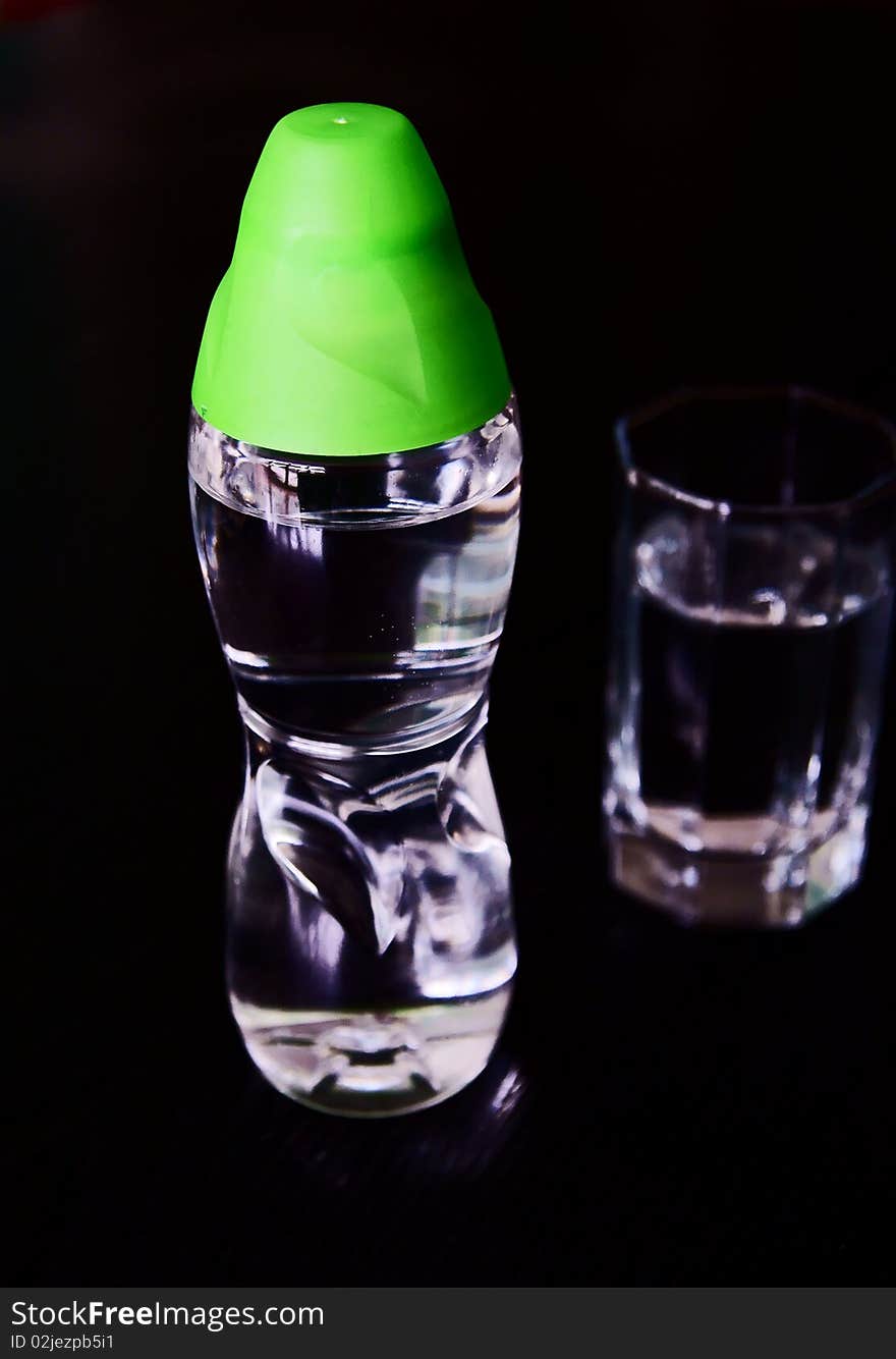 A Bottle Of Water With A Cup