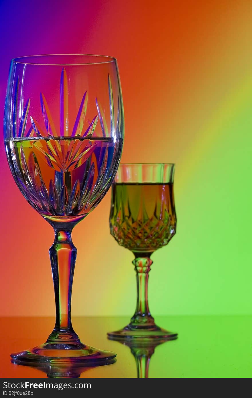 Two wine glasses on bright colorful rainbow background. Two wine glasses on bright colorful rainbow background