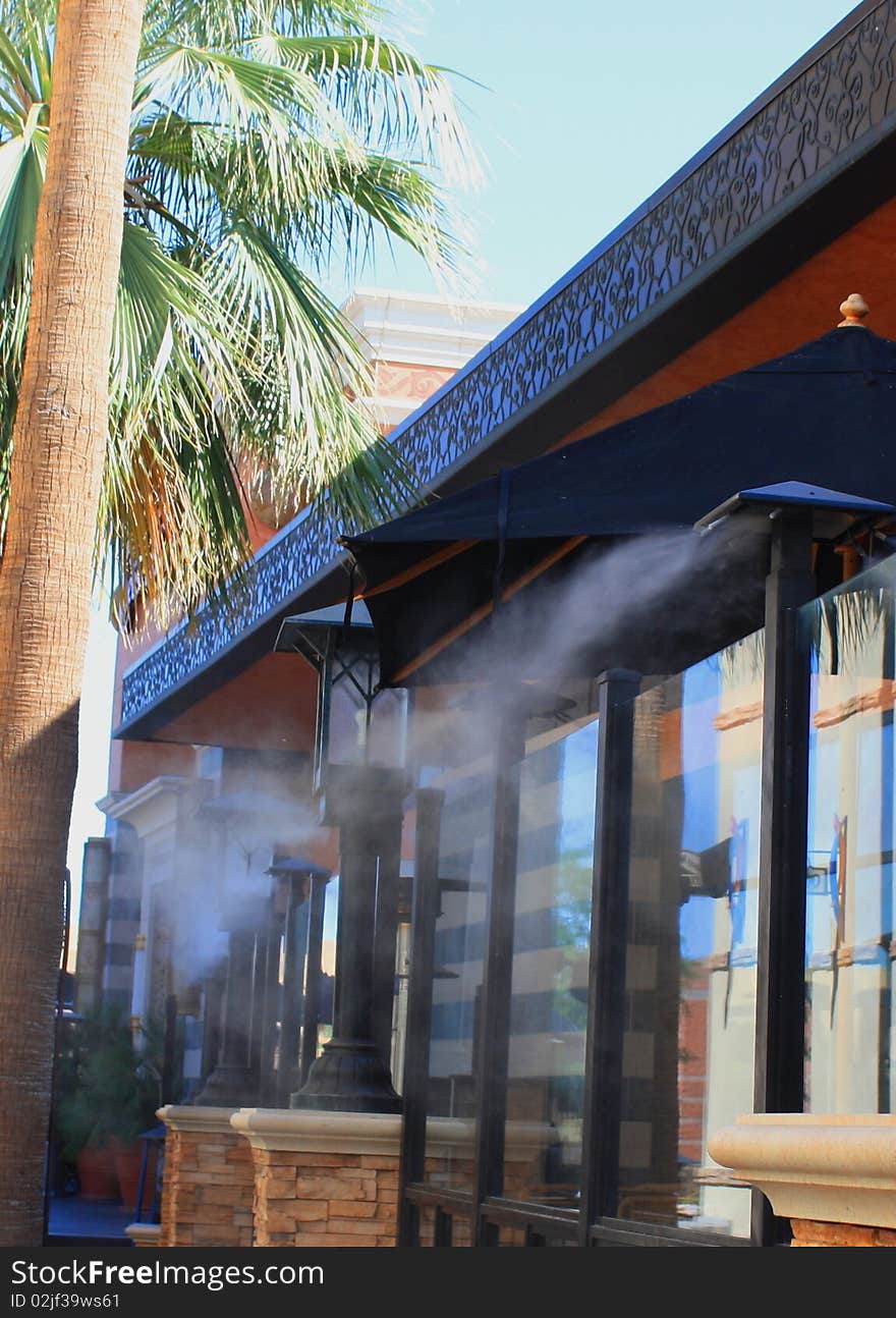 Mist sprayer in hot Weather in front of a restaurant. Mist sprayer in hot Weather in front of a restaurant.