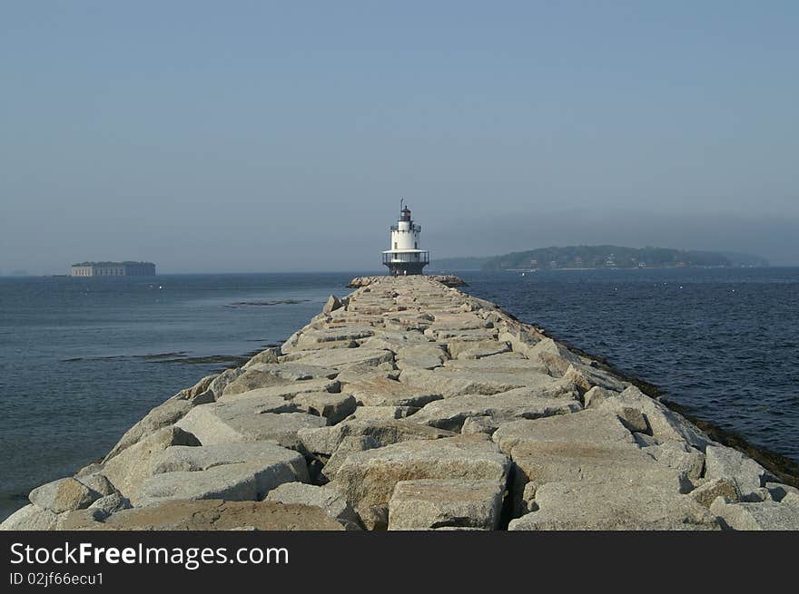 The stone pier lends a walkway to the Spring Point Lighthouse located in the harbor of Portland, Maine. The stone pier lends a walkway to the Spring Point Lighthouse located in the harbor of Portland, Maine.