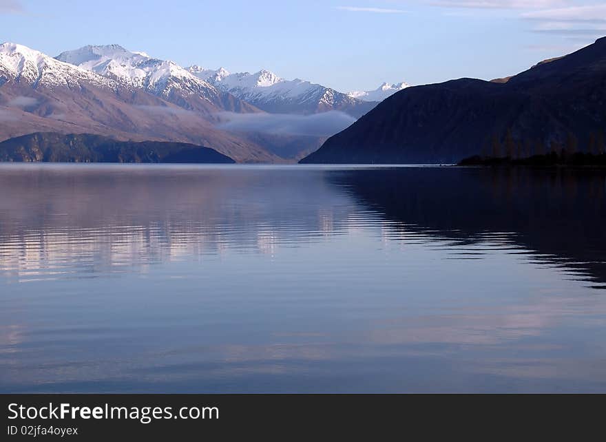 Spectacular Lake Wanaka, New Zealand with early morning mist.