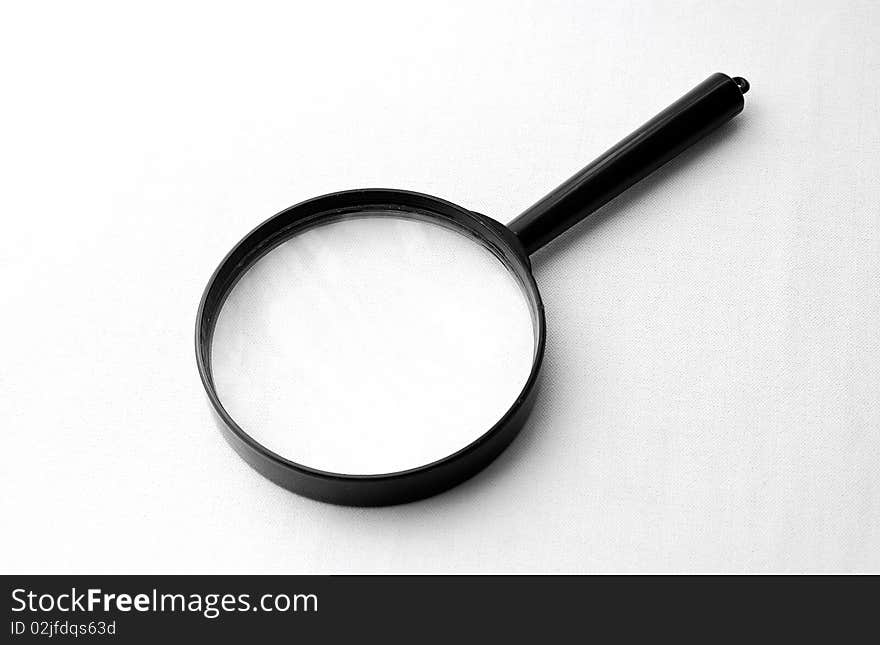 A simple magnifying glass over white background