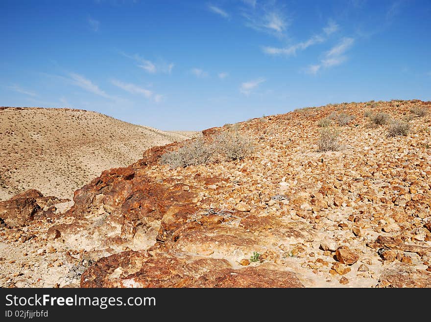 Ancient rocks under blue sky. Desert Negev, Israel.