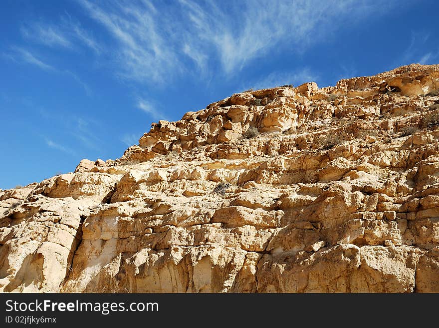 Ancient rocks under blue sky. Desert Negev, Israel.