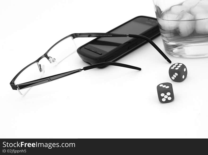 Glasses, mobile phone, whisky and dices close-up. Glasses, mobile phone, whisky and dices close-up.