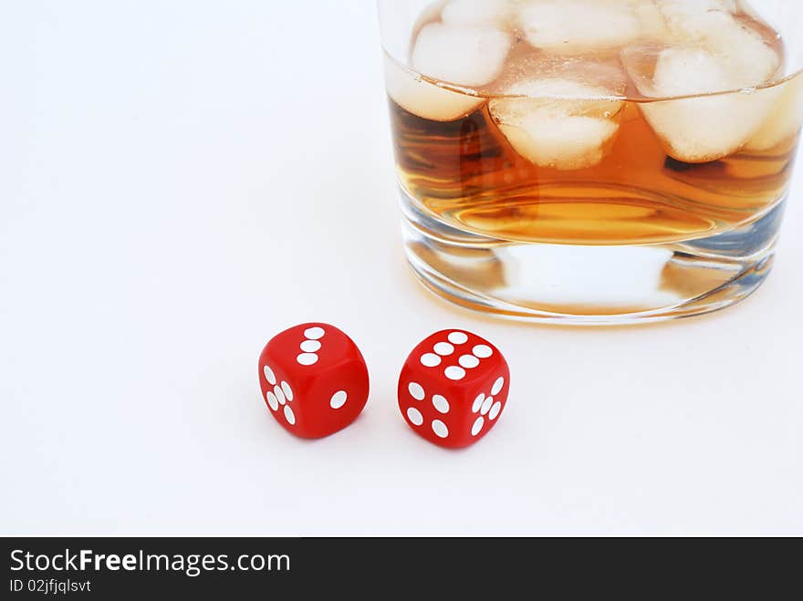 Glass of whiskey with ice cubes and dices. Glass of whiskey with ice cubes and dices.