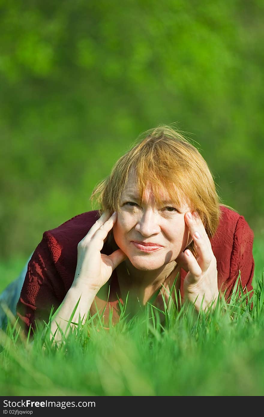 Smiling senior woman  in a spring  meadow