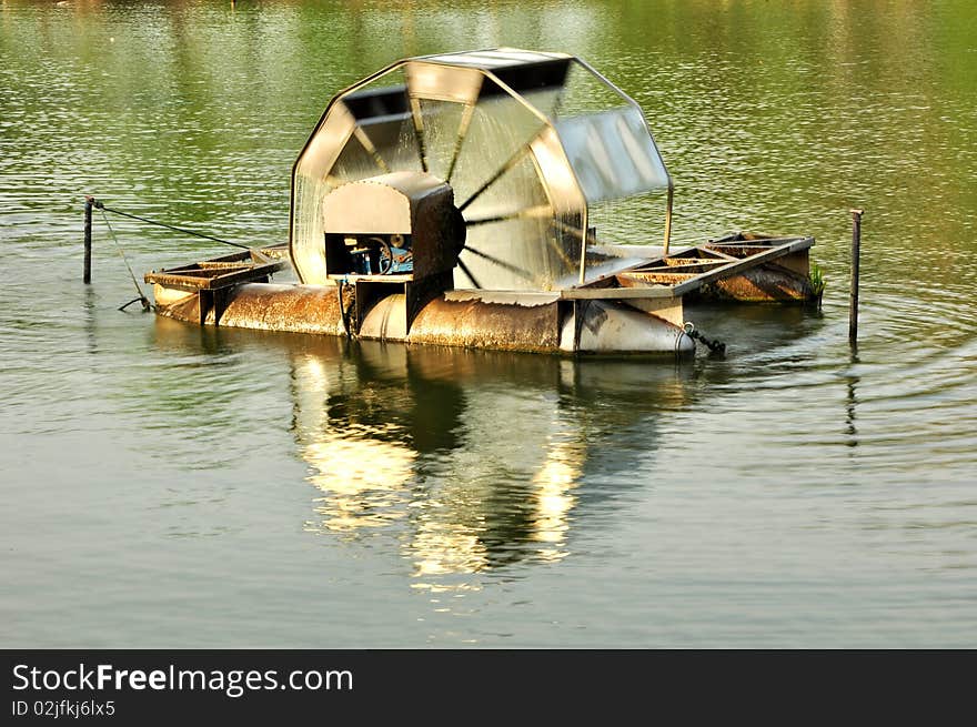 Working water wheel in public park. Working water wheel in public park.