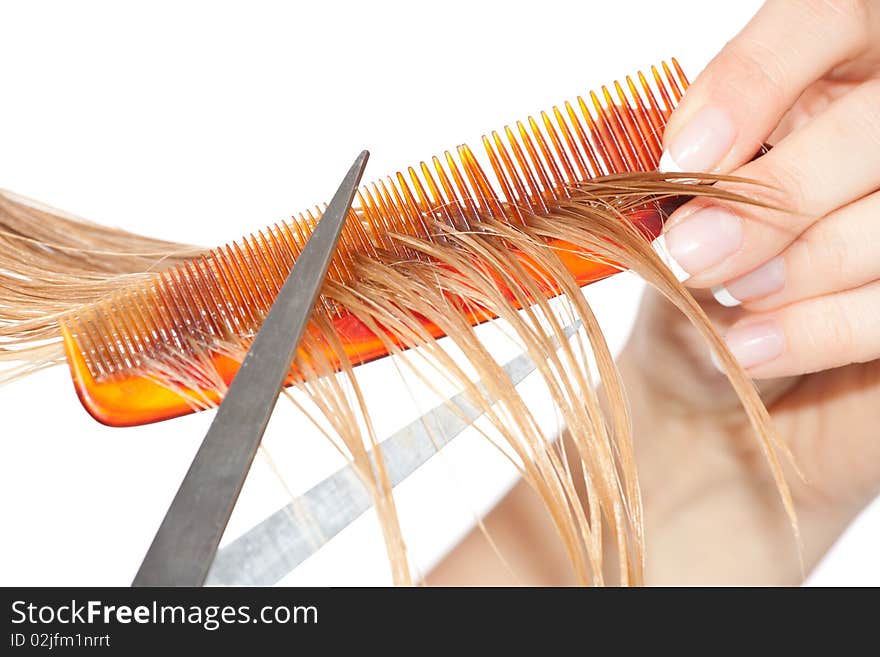 Woman cutting hair close-up on white isolated background