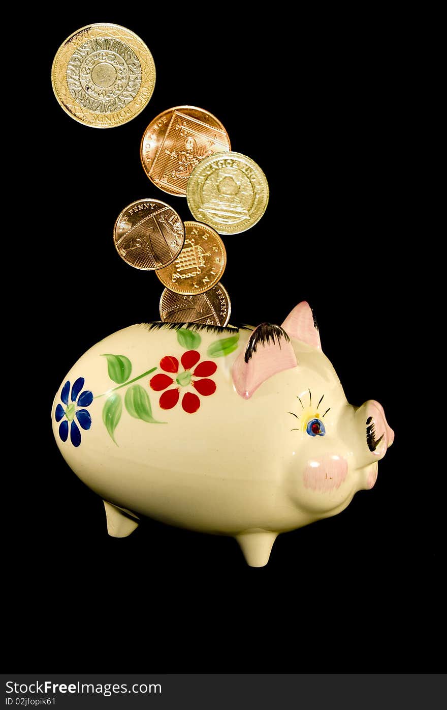 Old china piggy bank with flower pattern on a black background in portrait format