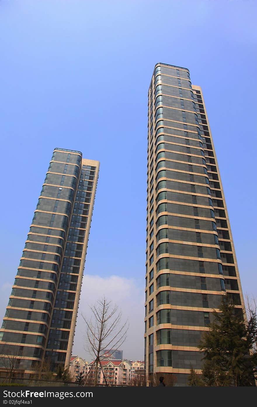 Two business buildings against  blue sky. Two business buildings against  blue sky.