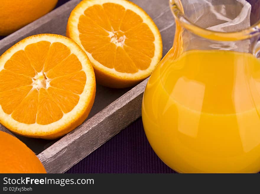 Orange juice in carafe with oranges