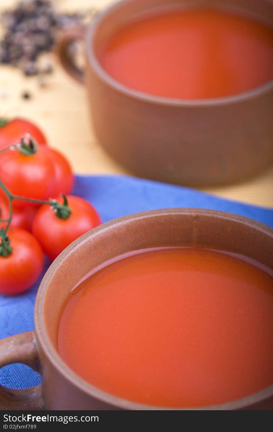 Two cups of tomato soup with tomatoes. Two cups of tomato soup with tomatoes