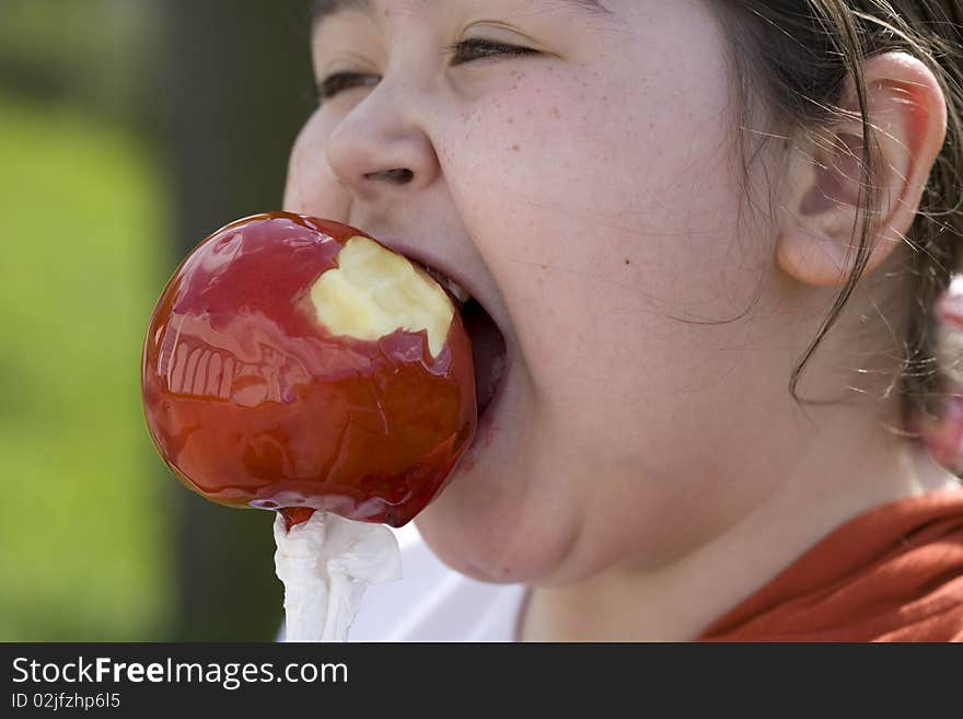 Little girl eating apple outdoor. Little girl eating apple outdoor