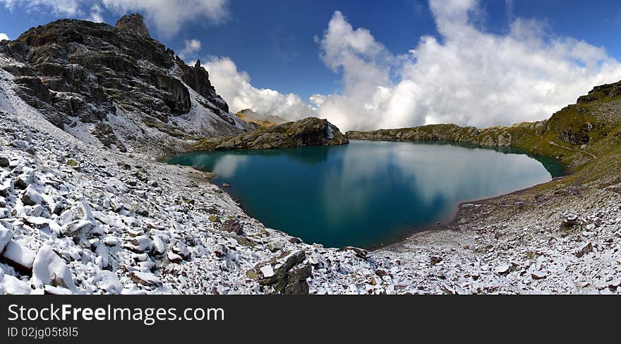 Blue lake in winter landscape - Swiss Alps