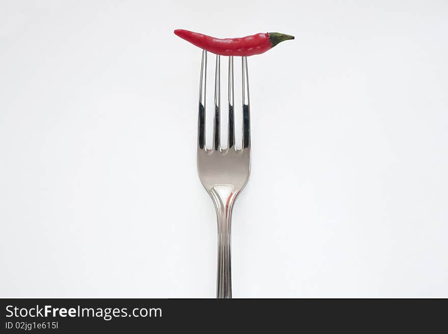 Red chili pepper on fork