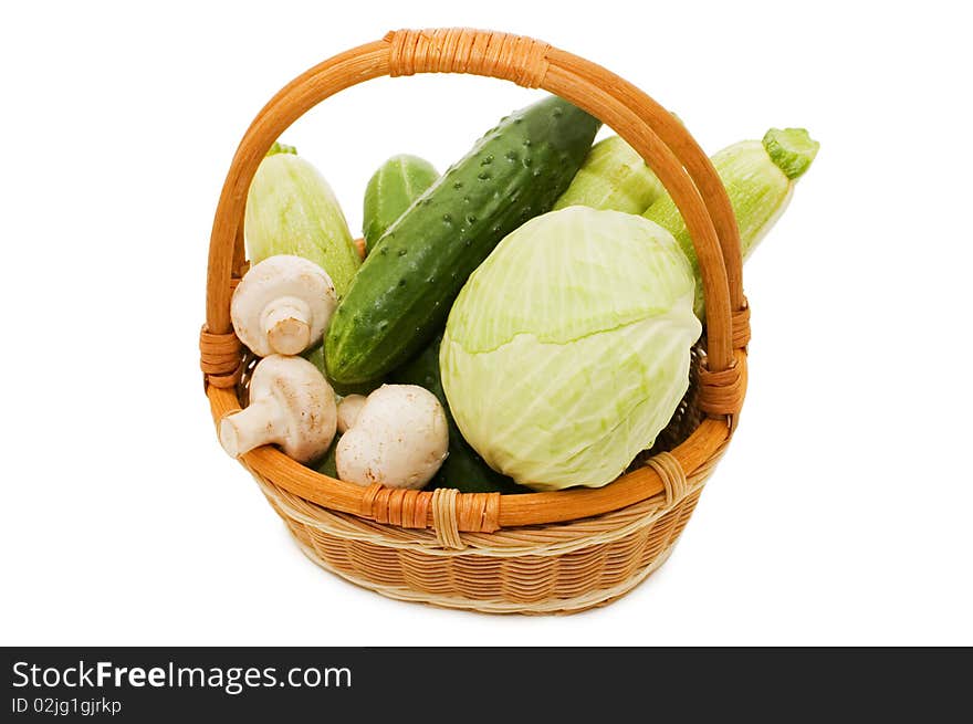 Wattled basket with vegetables isolated on white