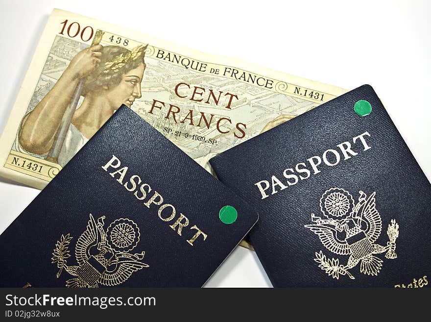 French 100 Franc bank note and 2 passports isolated. French 100 Franc bank note and 2 passports isolated.