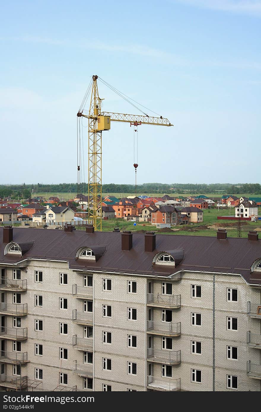 Construction of multi-story brick apartment house on the outskirts of the city. Construction of multi-story brick apartment house on the outskirts of the city