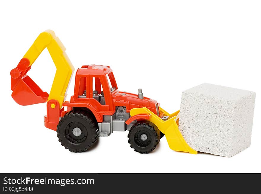 Toy tractor and the block isolated over white