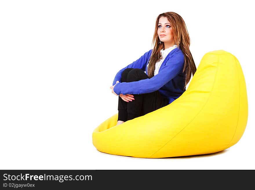 Picture of a attractive young girl in blue on armchair. Isolated on white. Picture of a attractive young girl in blue on armchair. Isolated on white.