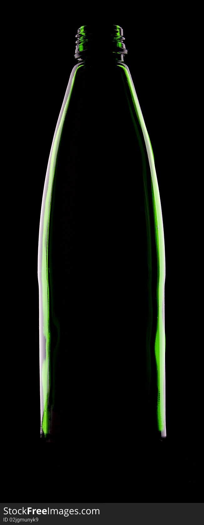 Empty green glass bottle on the black background. Empty green glass bottle on the black background