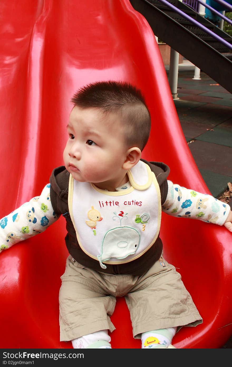 Lovely Chinese baby is playing in the park