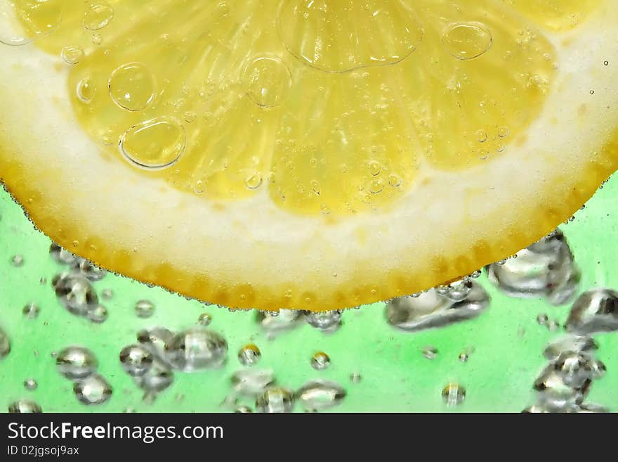 Close up on a lemon slice in a cocktail.