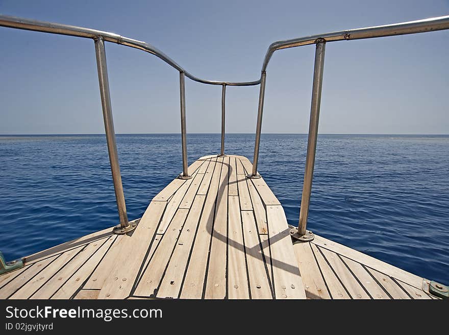 View of the ocean looking from the bow of a sailing yacht. View of the ocean looking from the bow of a sailing yacht