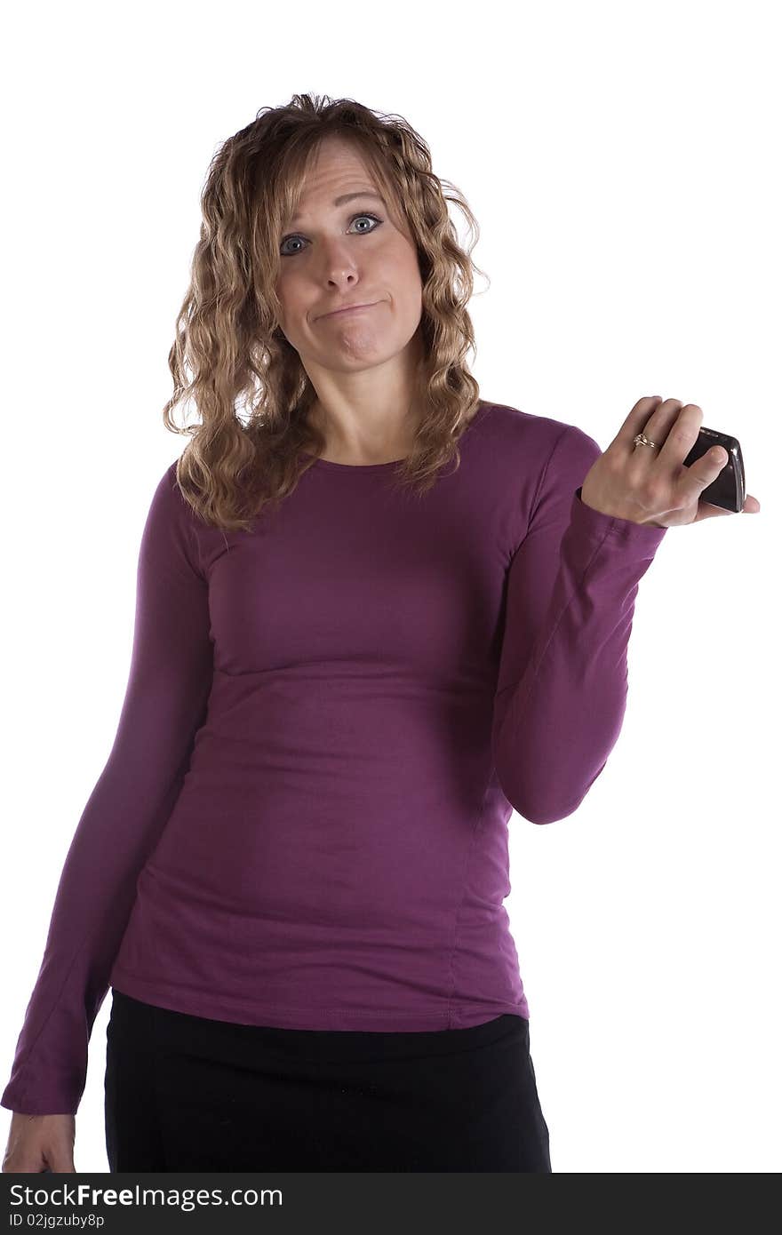 A woman in purple is holding her cell phone and making a funny expression. A woman in purple is holding her cell phone and making a funny expression.