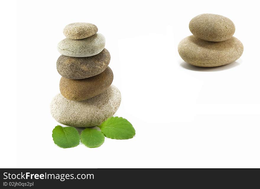 Stack of pebbles and leaf on white background. Stack of pebbles and leaf on white background