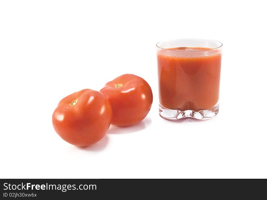 Fresh tomatoes and a glass full of tomato juice