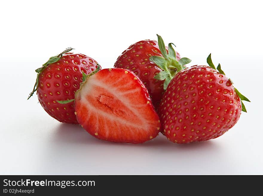 Group of ripe fresh strawberries isolated on white. Clipping path included. Group of ripe fresh strawberries isolated on white. Clipping path included