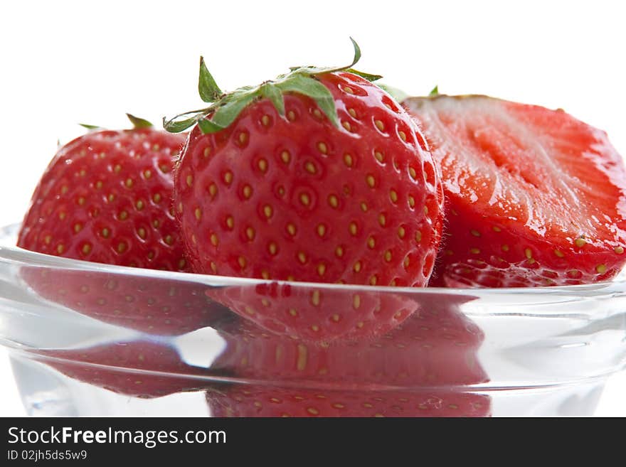 Group of ripe fresh strawberries in glass bowl isolated on white. Group of ripe fresh strawberries in glass bowl isolated on white