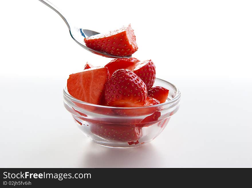 Group of ripe fresh strawberries in glass bowl isolated on white. Group of ripe fresh strawberries in glass bowl isolated on white